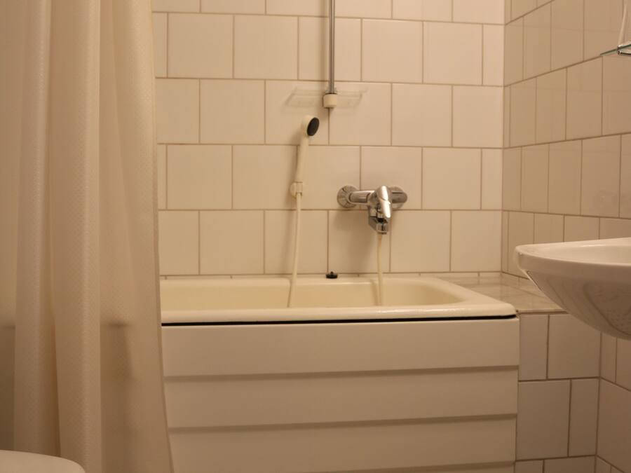 A bathroom with a bathtub, a sink, and a toilet.