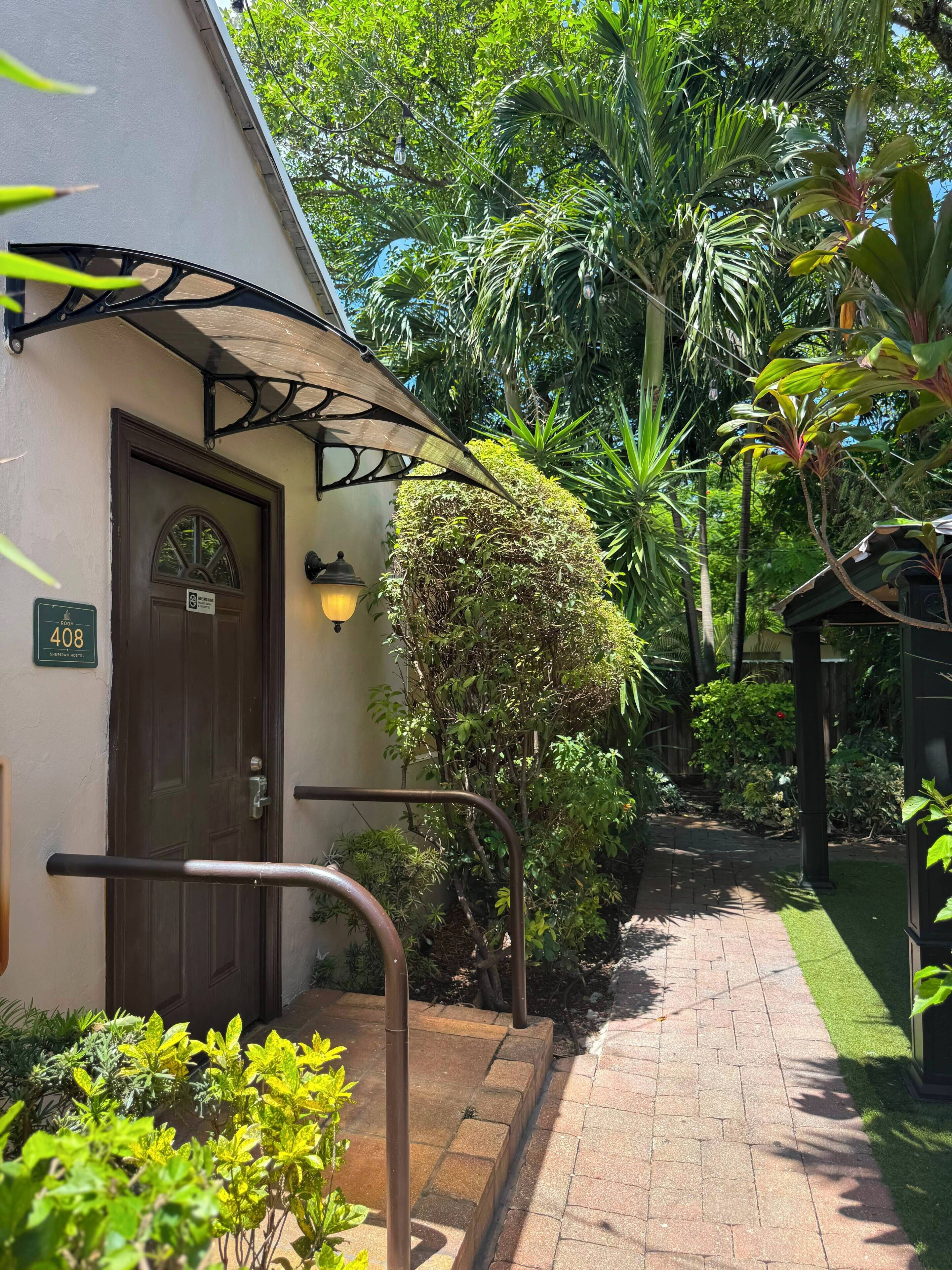 A hotel entrance with a door marked '408' and a sign indicating 'No Smoking.'