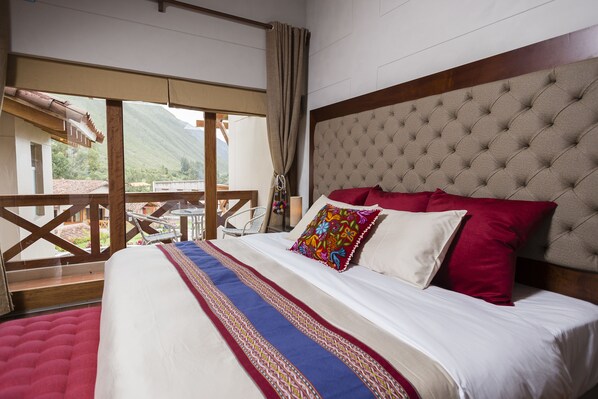 A bedroom with a large bed, a view of the outdoors, and a balcony. - Intiterra The Luxury Apart Hotel (Urubamba)