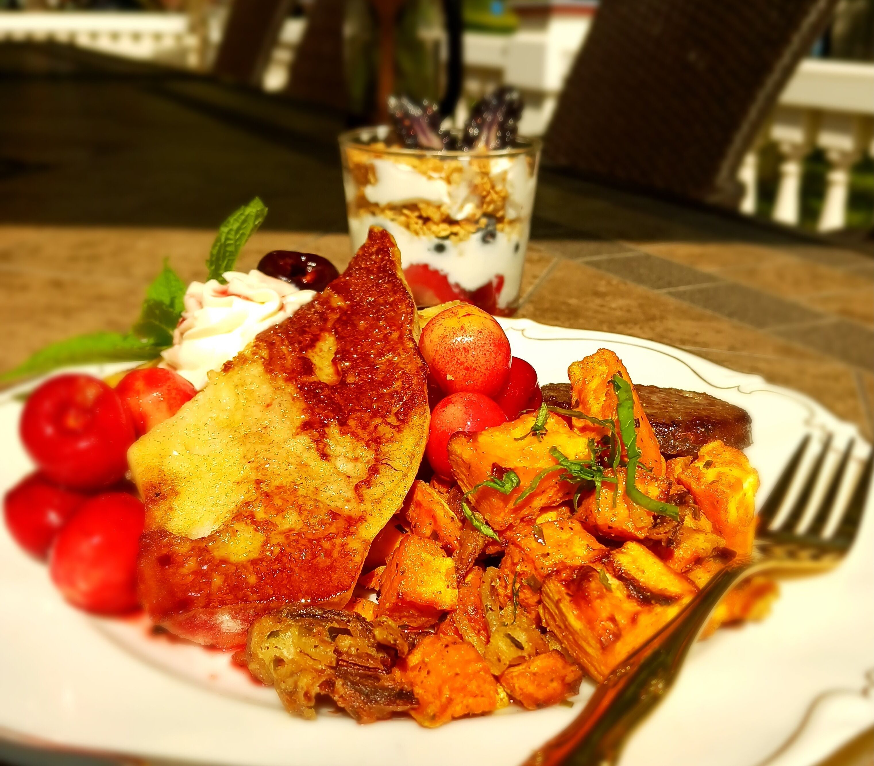 A plate of food with toast, roasted potatoes, and cherry tomatoes.