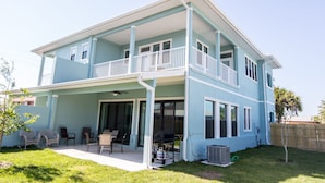 A two-story house with a covered patio, a balcony, and a backyard with chairs and a grill. - SOL: pool, 1 blk to the beach. 3b/3.5ba. beach items, longbrd, picklball close (Cocoa Beach)