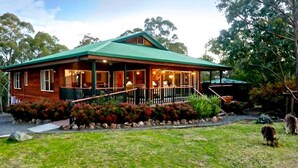 A wooden house with a green roof, a porch, and a stone pathway. - Absolute  luxury, surprising additions, welcome hamper & wine, cheese & biscuits (Hunter Valley)