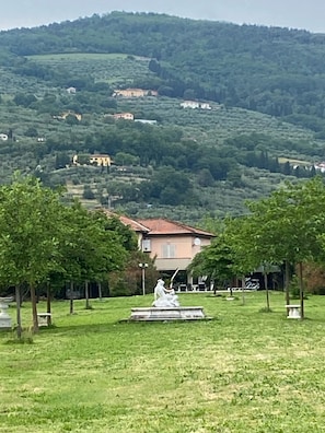 A rural landscape with a house surrounded by trees and a statue in the foreground. - A VALE OF HOUSE - for rural holiday accommodation (Pistoia)