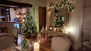 A dining area with a Christmas tree, candles, and a mirror with lights. - Luxury Barn nr. Gastro-pub & Lake. Ideal Base for Hay, Ludlow, Hereford.Sleeps 4 (Titley, nr. Kington)
