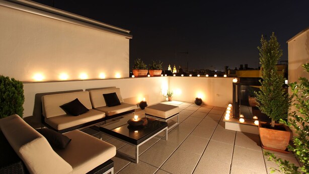 A rooftop terrace with a sofa set, a coffee table, and potted plants. - Corral del Rey Terraza Sevilla Duplex, chillout terrace (Sevilla)