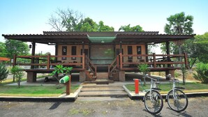 A building with a covered entrance, steps leading up to it, and a bicycle parked in front. - Bannraiphontawan (Nong Khai)