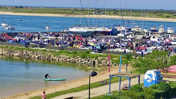 A marina with boats docked, a sandy beach, and a crowd of people. -  MORBIHAN - SPLENDID VIEW ON THE RIA AND THE BAR OF ETEL - 15 METERS FROM THE BEACH  (Étel)