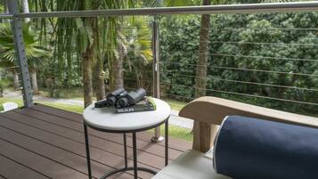 A balcony with a table holding binoculars and a book titled "Wildlife of Tropical Queensland".