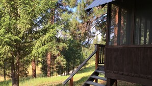 A wooden cabin with a wooden staircase leading to a deck. - SWAN VALLEY BUNKBED EFFICIENCY IN CONDON (Condon)