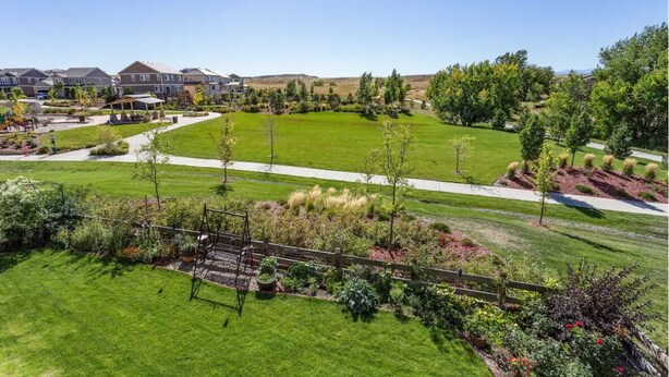 A residential area with houses, a well-maintained lawn, and a playground. - Charming 6-BR Home with Open Space & Park, Ideal for Gatherings (Parker)