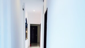 A hallway with a marble floor, white walls, and a door marked "3.1". - Phu Tai Center Hotel (Quy Nhon Tay)