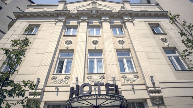 A hotel facade with classical architecture, including columns and decorative elements. - Public House Hotel (Belgrade)