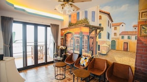 A room with a mural of a street scene, a ceiling fan, and several leather chairs. - Najie (Donghe)