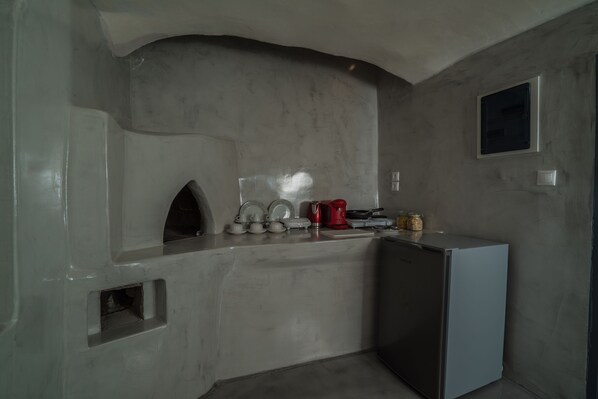Cocina compacta con horno integrado, refrigerador y microondas.