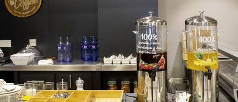 A coffee station with two dispensers labeled "100% natural, more, stronger, and smoother."