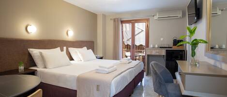 Ein modernes Hotelzimmer mit einem großen Bett, Nachttischen, einem Schreibtisch und einem Sessel.