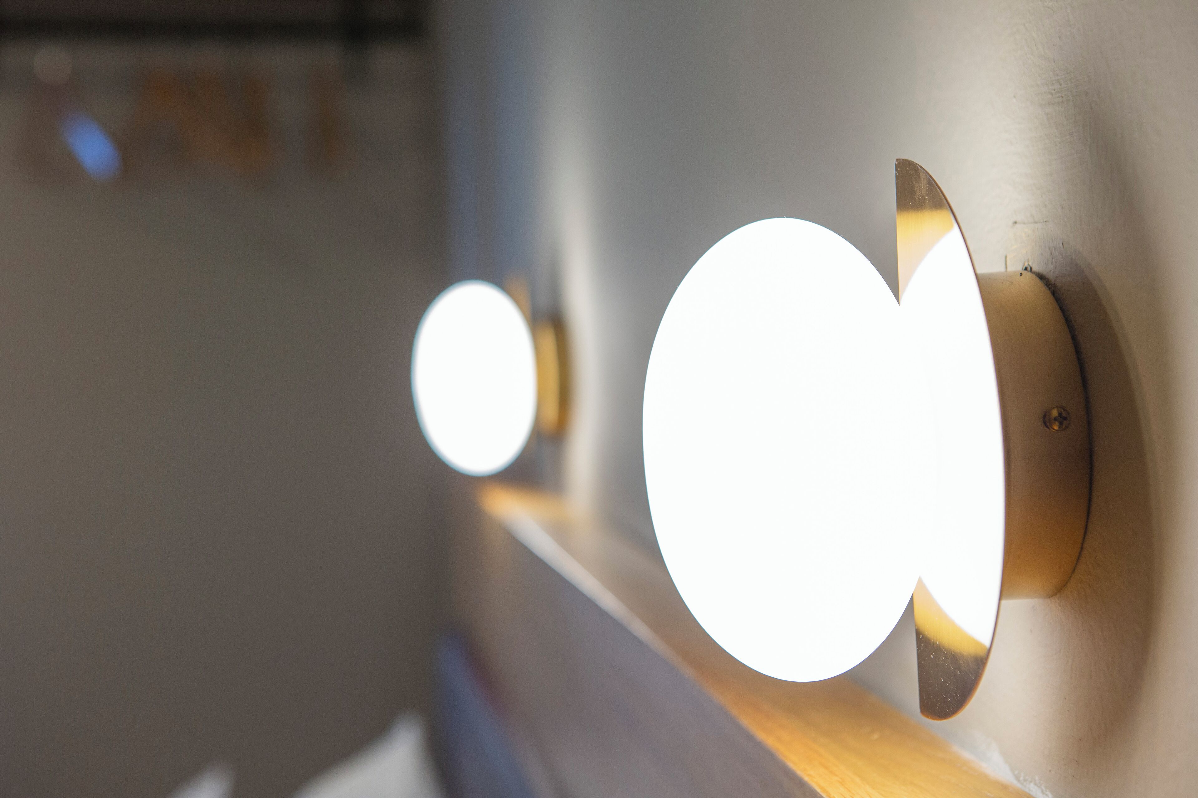 A wall-mounted light fixture with a circular design.