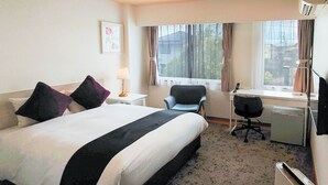 A hotel room with a bed, desk, chair, and a window with curtains. - REMBRANDT INN KAZUSA (Kimitsu)