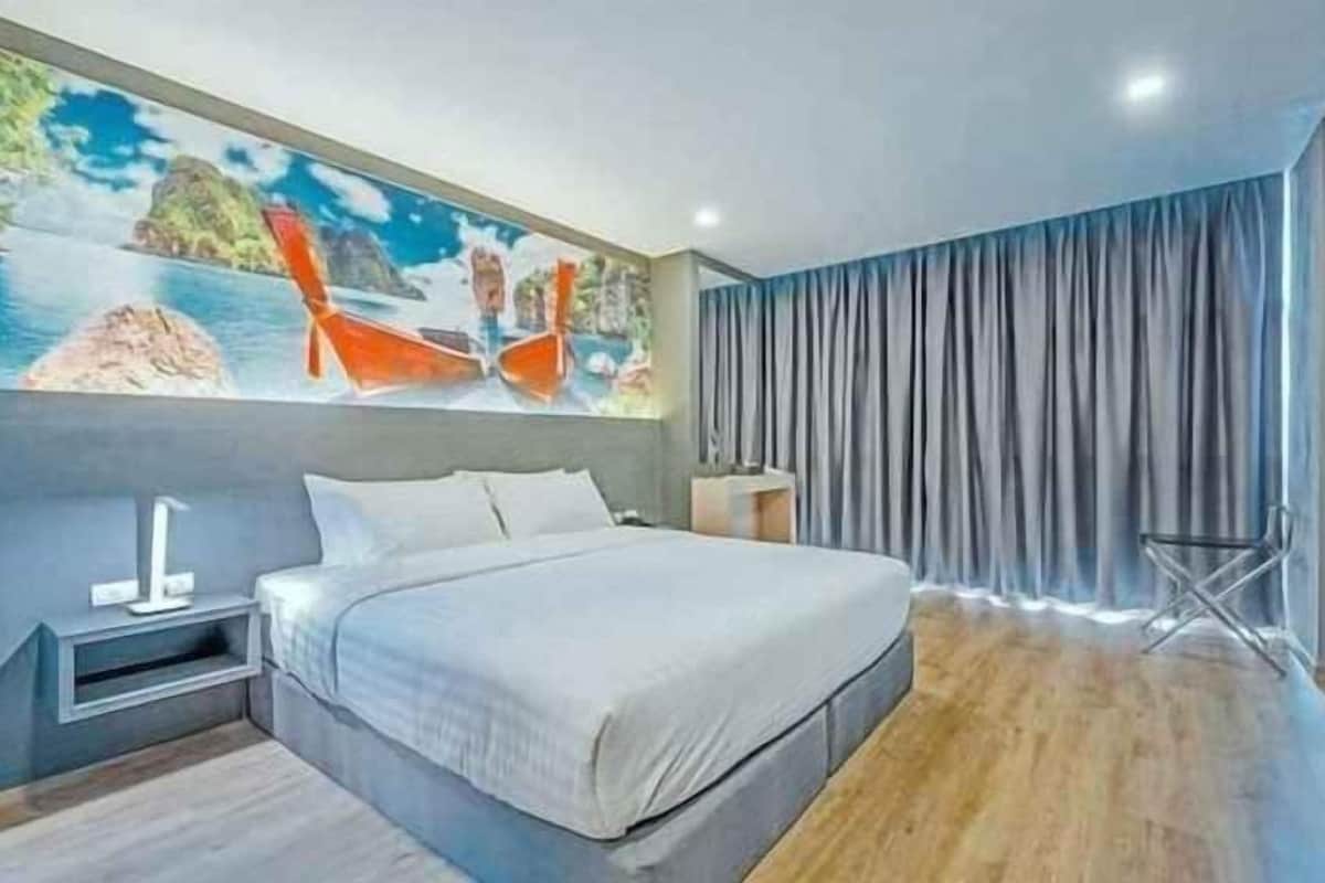 A modern bedroom with a bed, a nightstand, a wall-mounted shelf, and a large window with curtains.