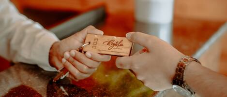 A person handing over a keychain with a tag to another person.