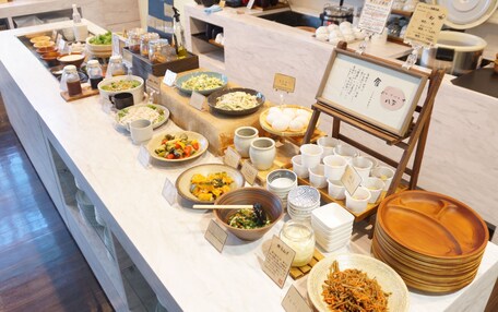 A buffet with various dishes and condiments.