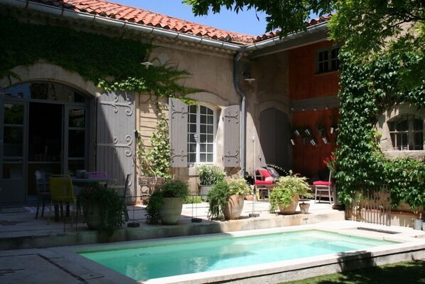 Una piscina al aire libre, tumbonas