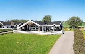 A row of modern, two-story cabins with large windows and a covered outdoor seating area. - Lovely home in Nordborg with sauna (Nordborg)