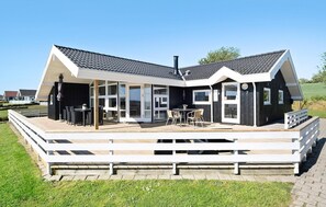 A modern house with a deck, large windows, and a chimney. - Lovely home in Nordborg with sauna (Nordborg)