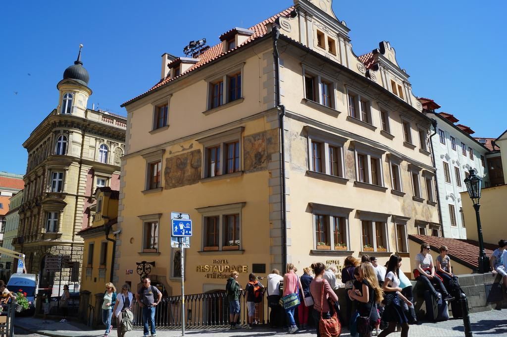 A historic building with a sign for a hotel and restaurant.