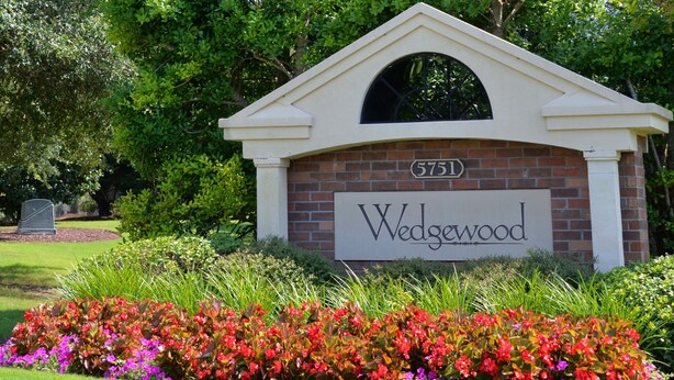 A brick building with a sign reading "Wedgewood" and the number "5751" on it.