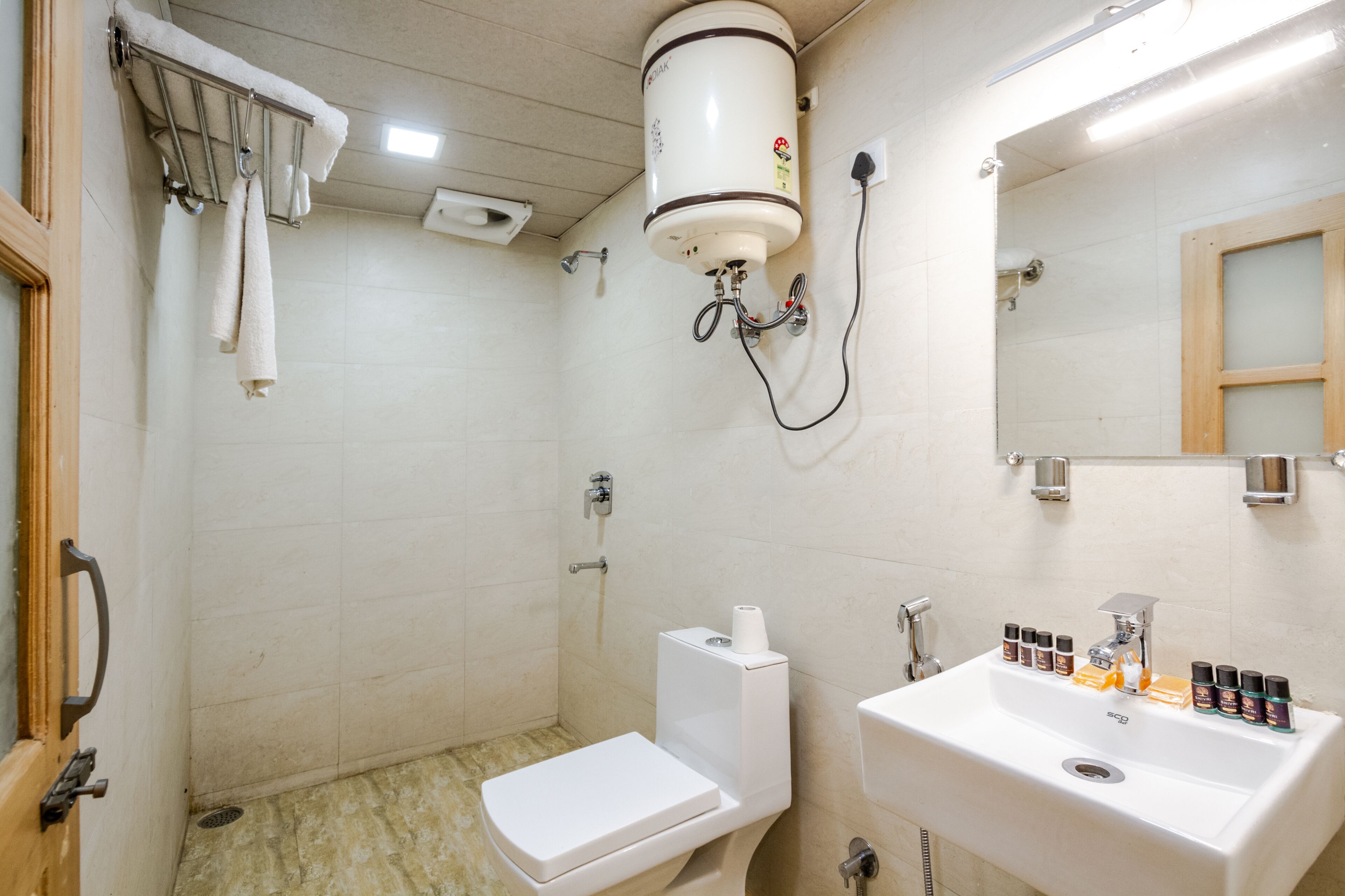 A bathroom with a toilet, sink, and shower.