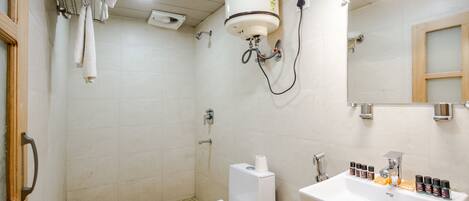 A bathroom with a toilet, sink, and shower.