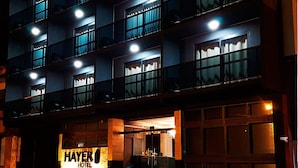 A multi-story hotel with illuminated signage reading "HAYER HOTEL".