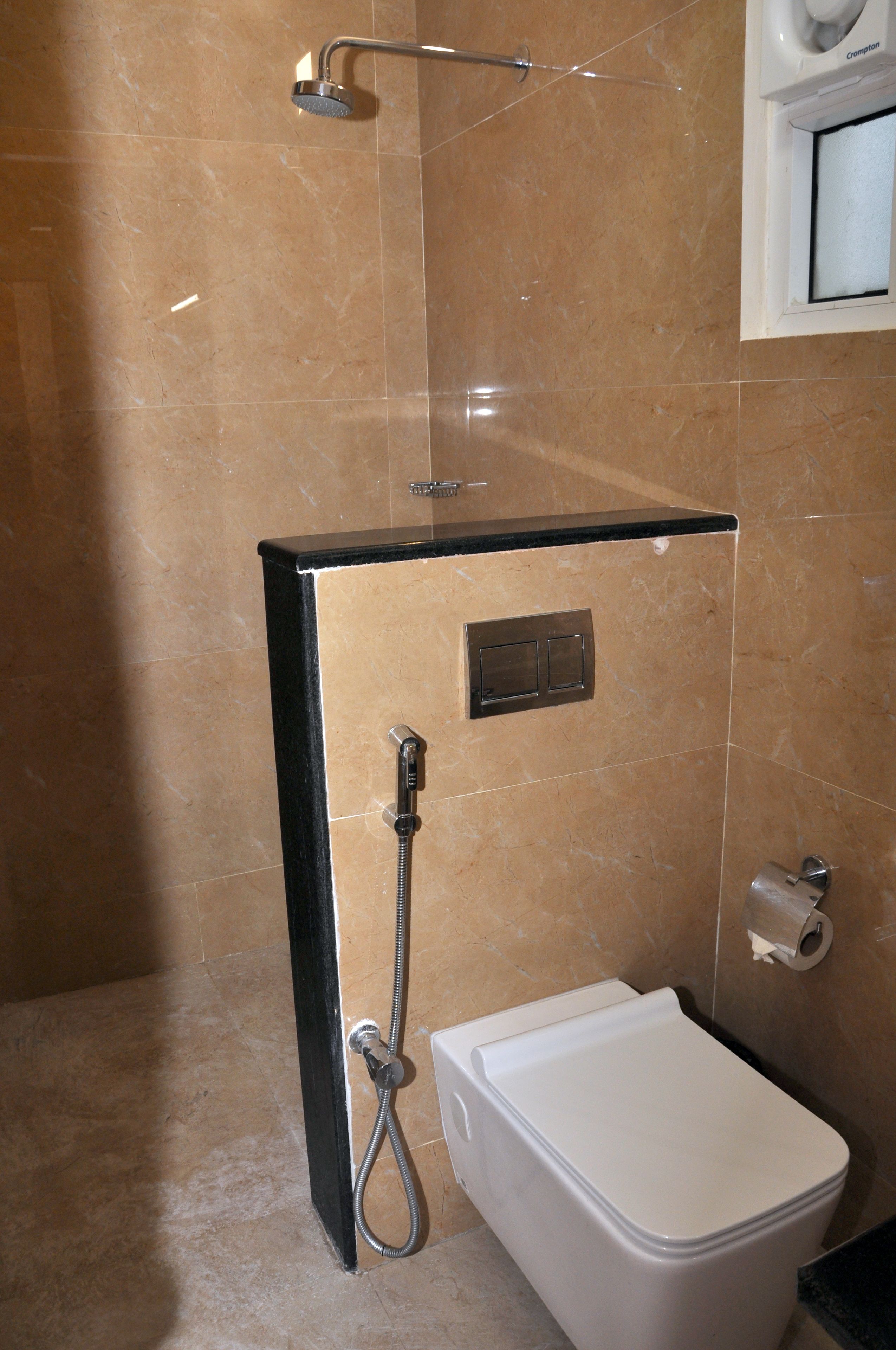 A bathroom with a shower enclosure, a toilet, and a towel rack.