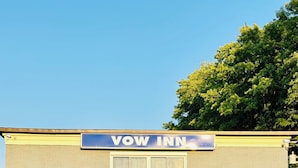 A Vow Inn building with a sign, a door, and windows. -  VOW MOTEL LISTOWEL ON (North Perth)