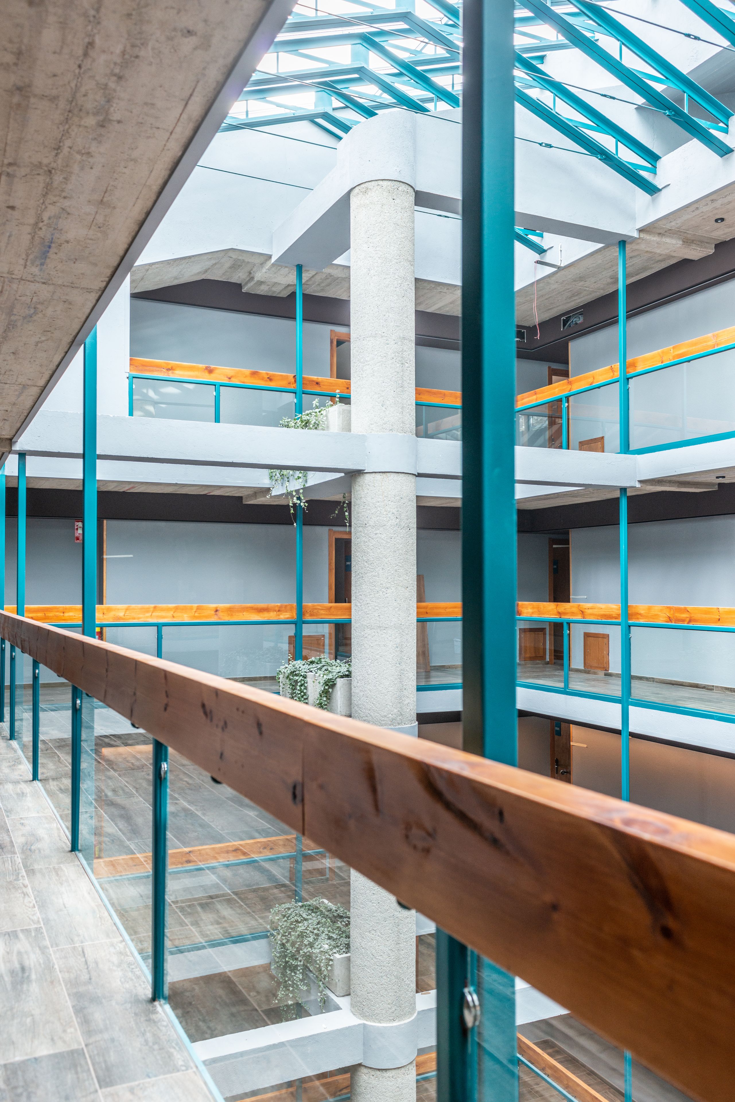 A multi-level atrium with open spaces and wooden railings.