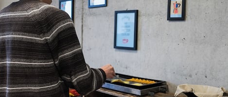 A person preparing food at a counter with various ingredients and utensils.