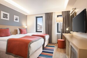 A hotel room with two beds, a flat-screen TV, a lamp, and a view of the city. - TRYP by Wyndham Ankara Oran (Ankara)