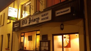 A building with a sign reading "Old Priory Guest House Restaurant."