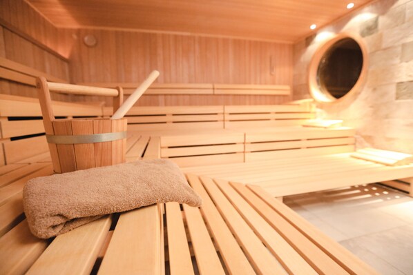A sauna with wooden benches and a towel on one of them.