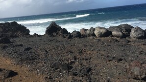 A rocky shoreline with waves crashing against the rocks.