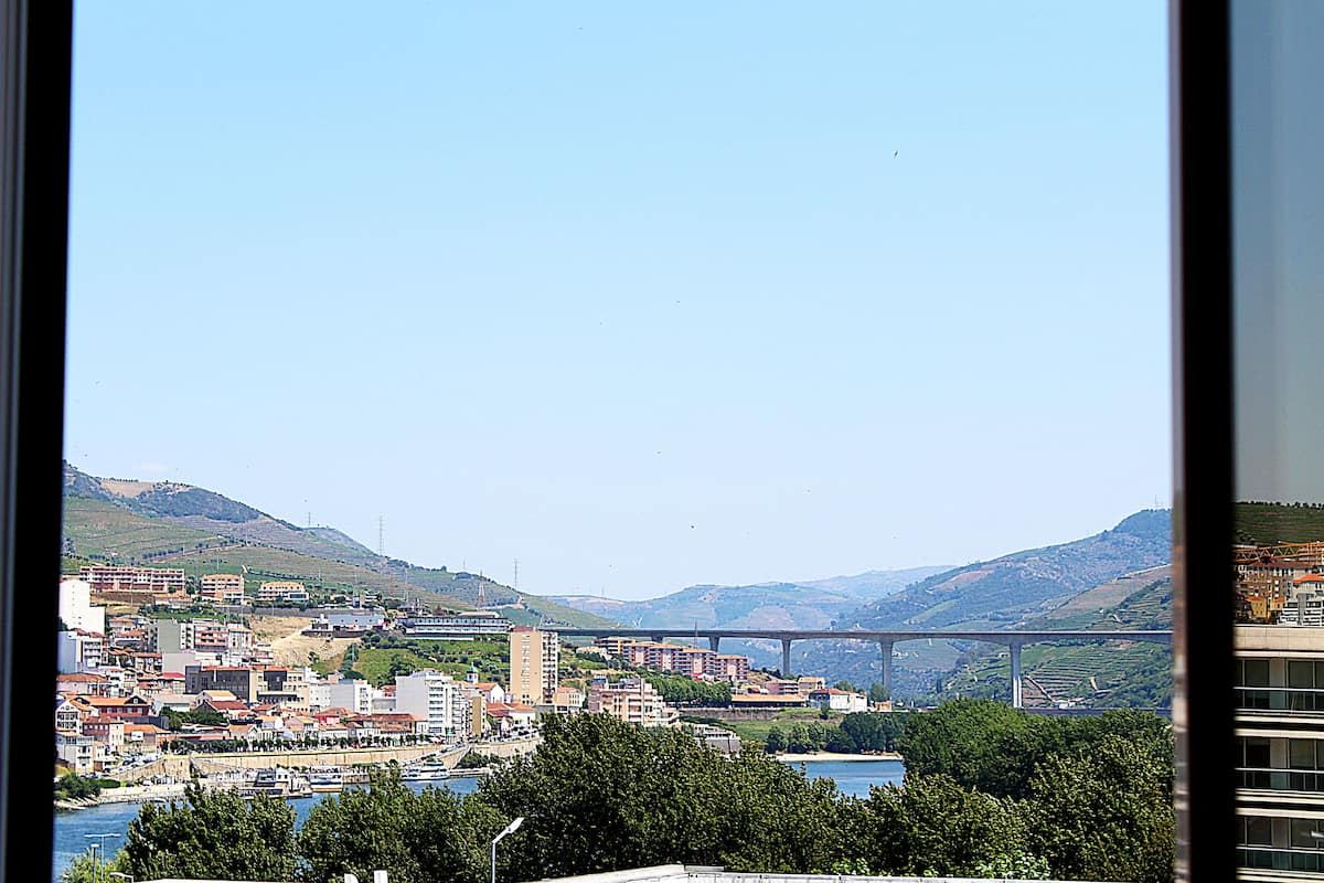 A cityscape with a prominent bridge, buildings, and a river.