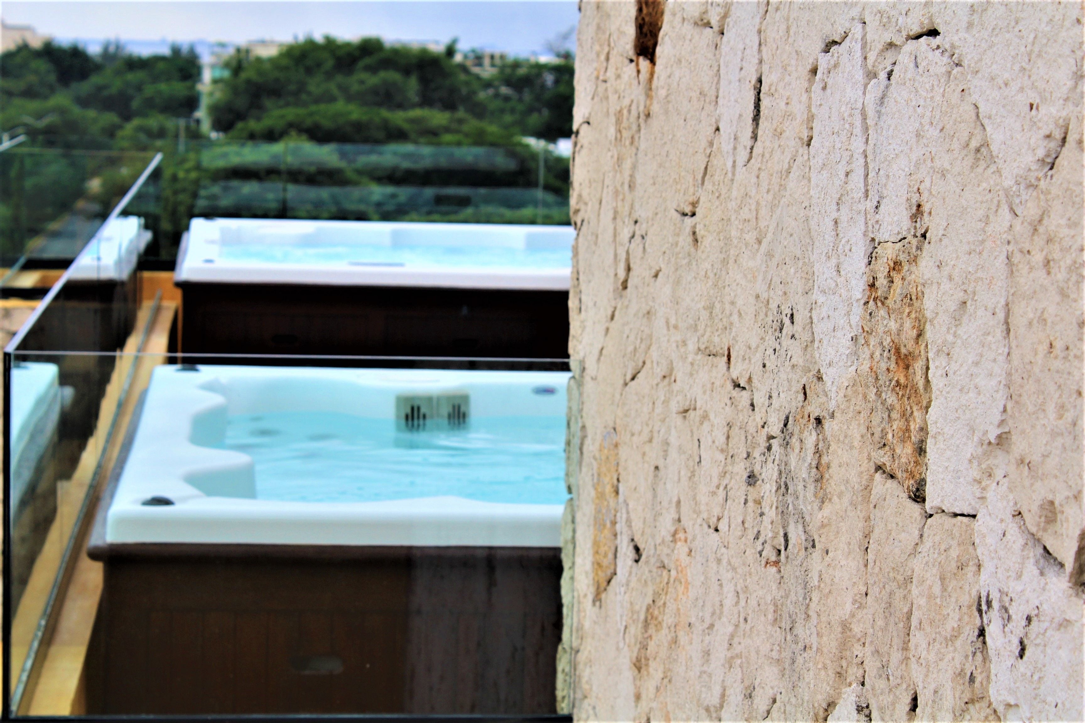 A hot tub with a view of a lush green landscape.