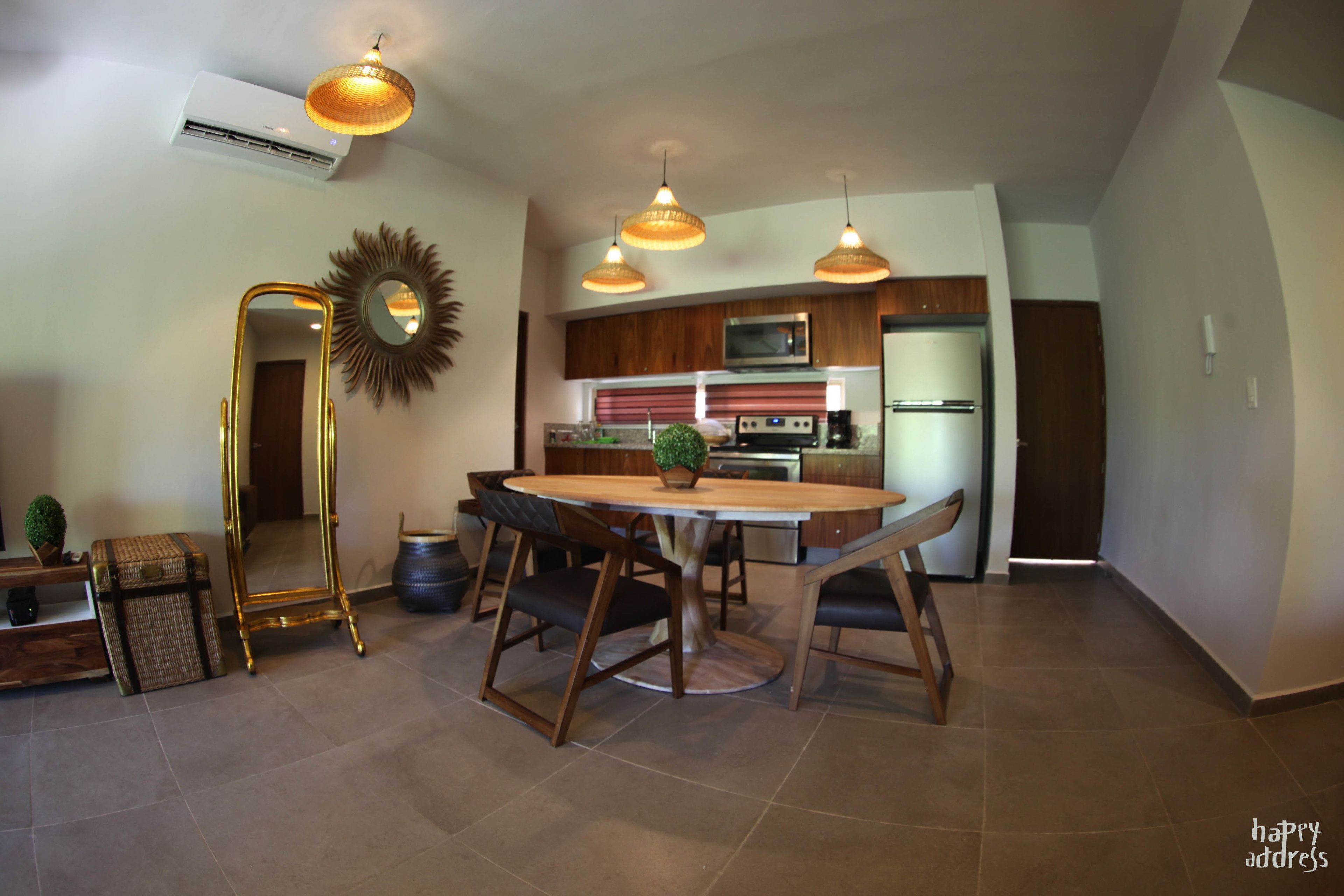 A modern kitchen with wooden cabinets, a stainless steel refrigerator, and a microwave.