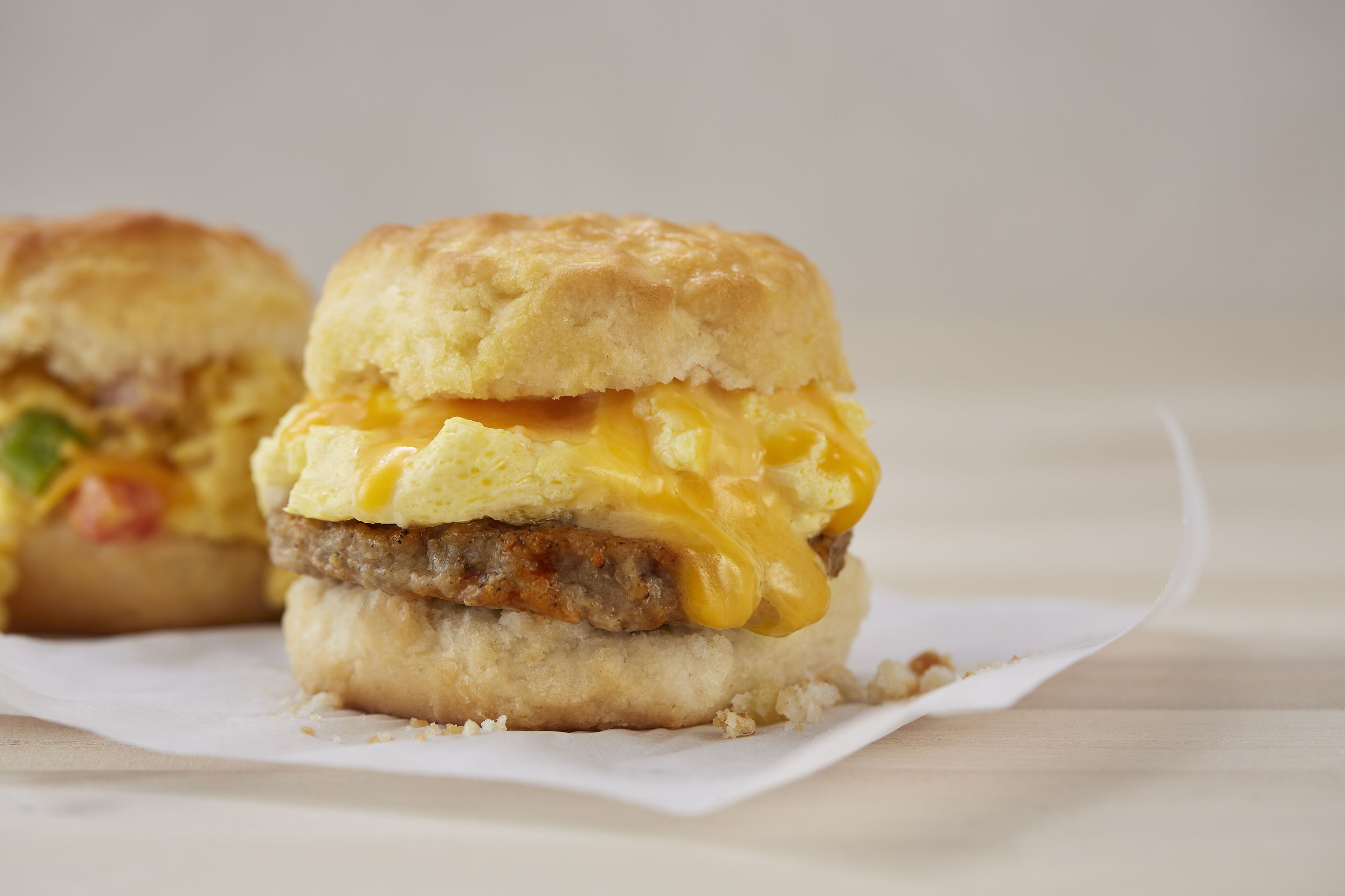 A breakfast sandwich with a biscuit, egg, and melted cheese.