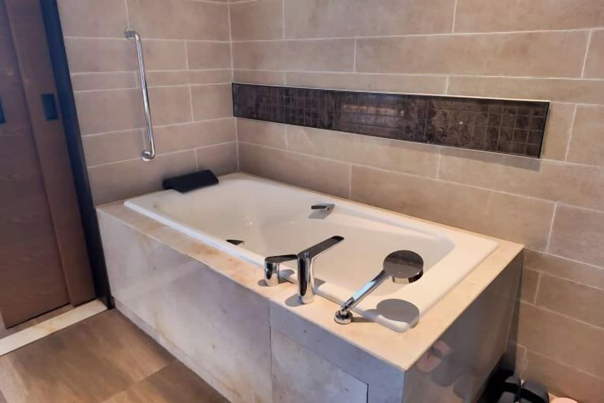 Separate tub and shower, rainfall showerhead, hair dryer, bathrobes