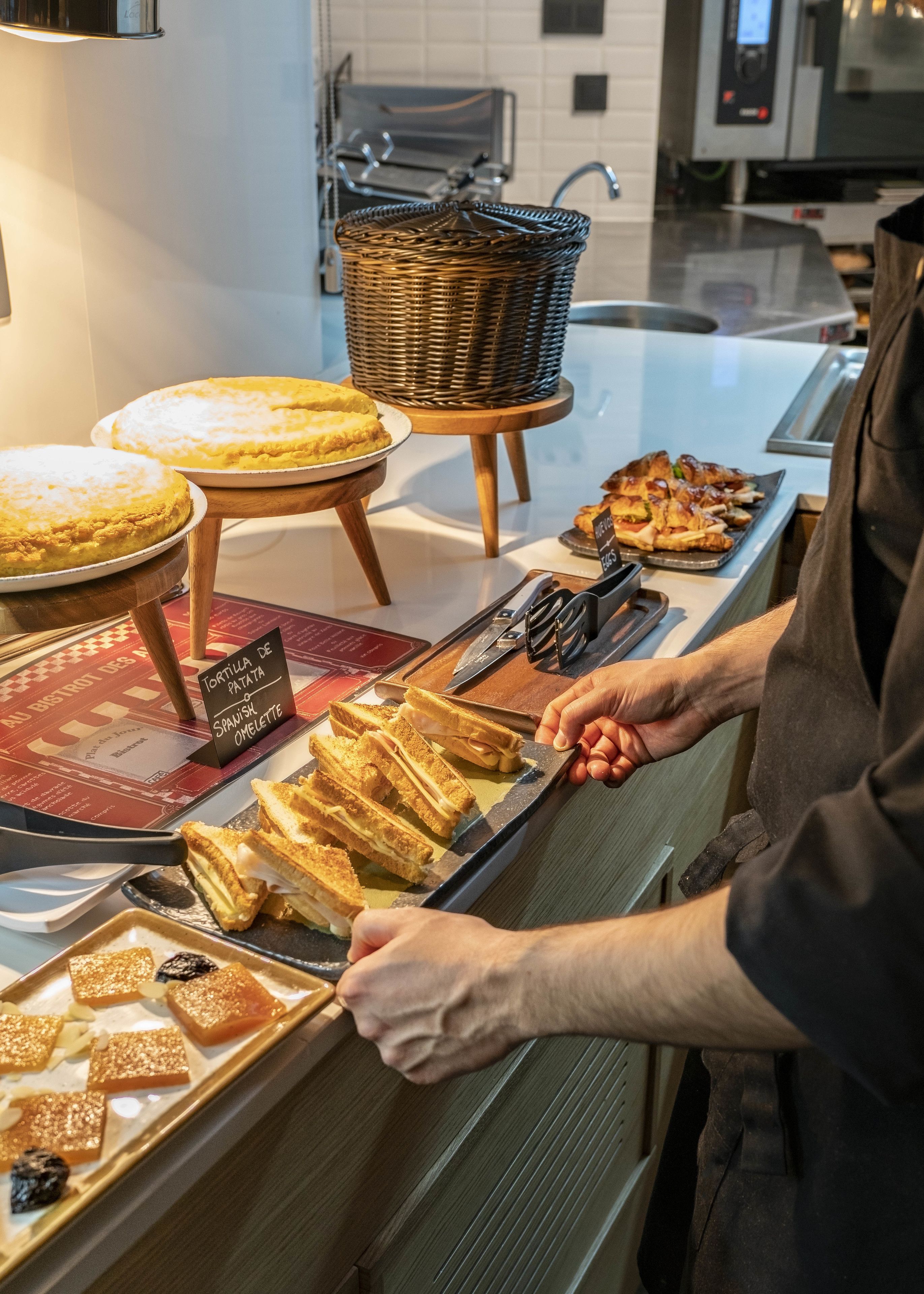 A bakery counter with various baked goods, including bread and pastries.