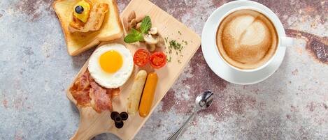 A breakfast tray with toast, eggs, bacon, sausages, tomatoes, and mushrooms on a wooden board, alongside a cup of coffee.