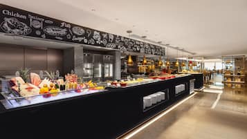 A buffet area with a variety of food options, a chalkboard menu, and modern lighting fixtures.