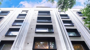 A modern building with a glass entrance and multiple windows. - Stey Wangfujing (Beijing)